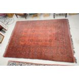 Eastern Wool Red ground Rug with floral and geometric design within a border, 215cm x 280cm