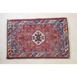 Iranian Wool Red Ground Rug with stylised pattern of birds and flowers within a border, 105cm x 67cm