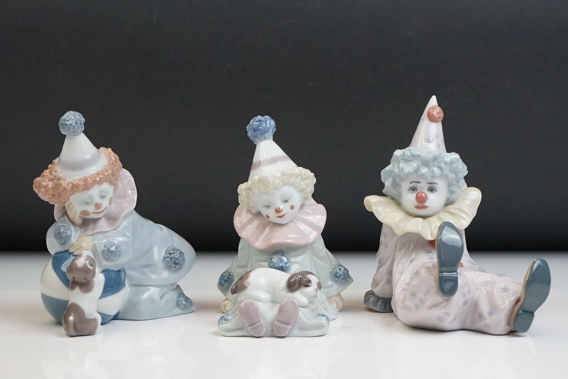 Three Lladro porcelain clown figures to include 5277 Pierrot With Puppy, 5812 Tired Friend and