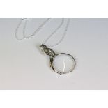 Silver pendant necklace in the form of a magnifying glass with cat finial