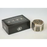 An ornate white metal hexagonal trinket box with decorative panels together with a metal trinket box