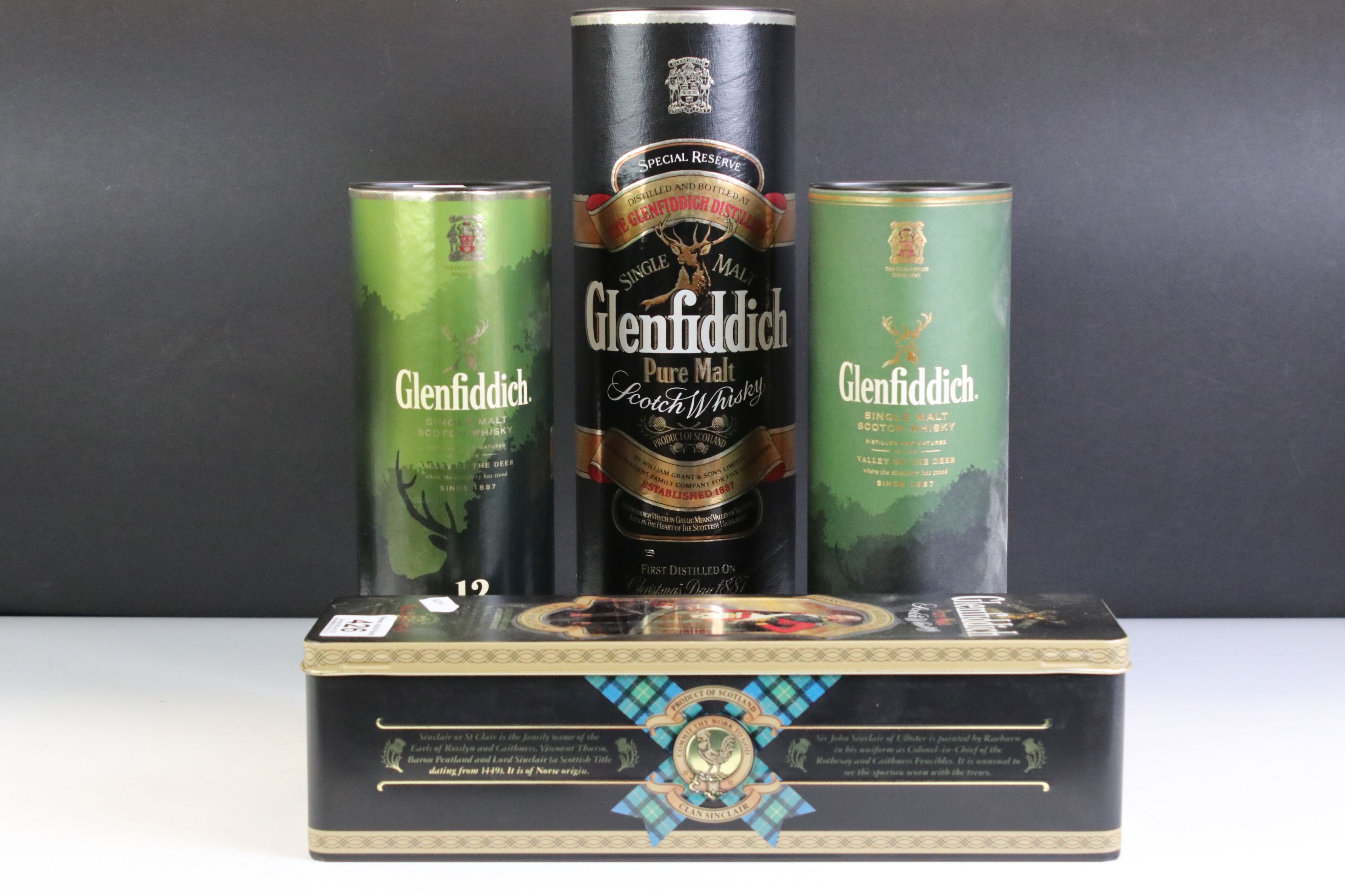 A collection of four boxed bottles of Glenfiddich whisky.