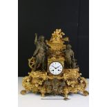 An antique French gilt mantle clock with decorative ironmonger figures.