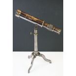 Brass cased telescope on tripod stand