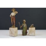 A pair of cold painted spelter early 20th century figures on stone bases.