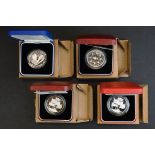A collection of four Royal Mint United Kingdom silver proof crown coins to include the coronation