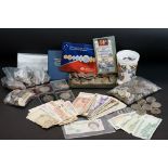 A collection of mixed foreign and British coins and banknotes to include some silver examples,