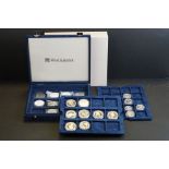 A collection of mainly commemorative coins to include silver proof examples within capsules housed