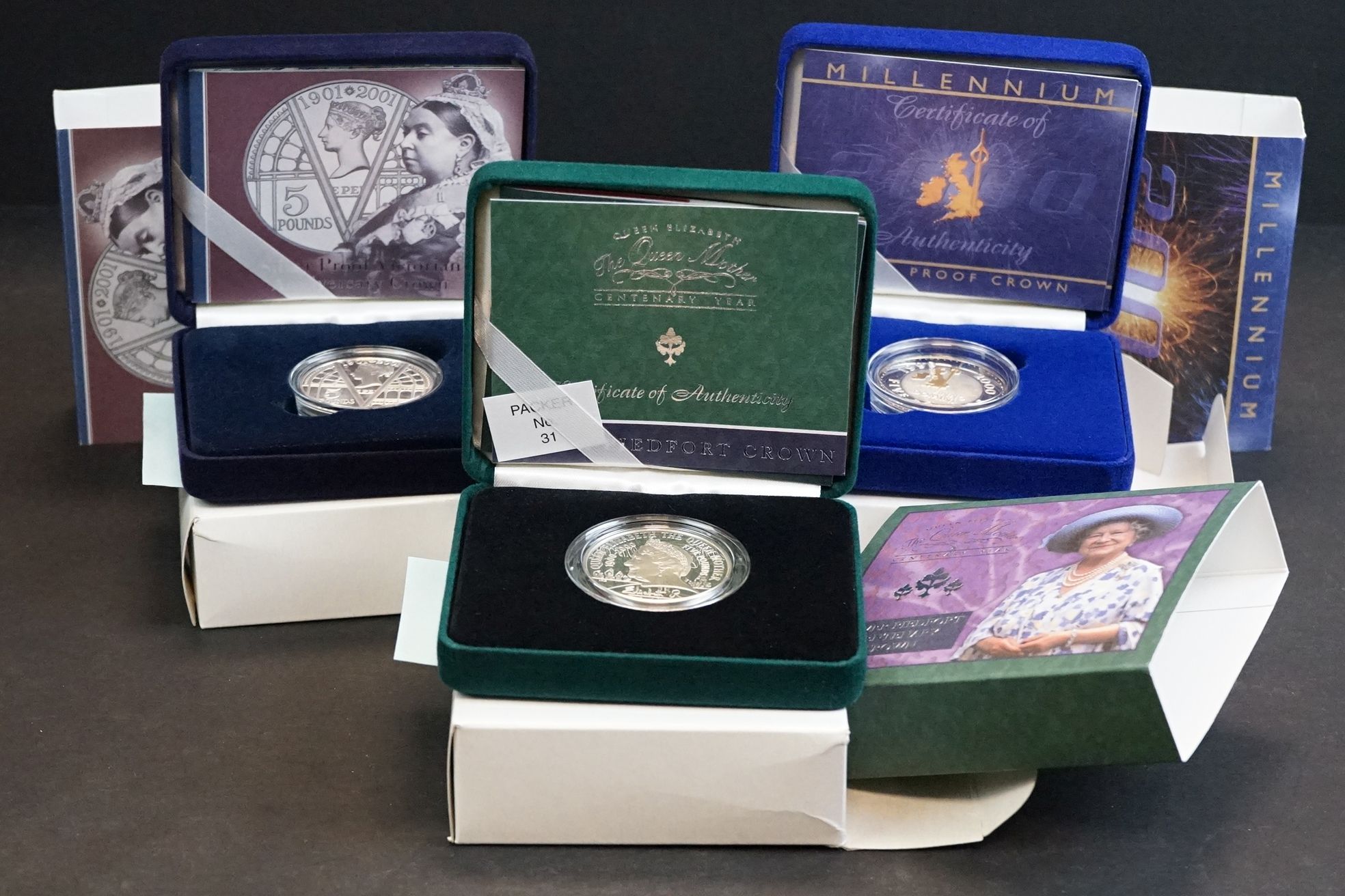 A collection of three Royal Mint United Kingdom silver proof crown coins to include the 2000