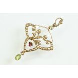 Early 20th century peridot, ruby and seed pearl unmarked yellow gold pendant, the openwork trefoil