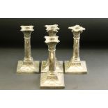 Four matched Victorian silver candlesticks, beaded drip tray, cast ribbon and bow, swag and garland