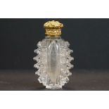 Victorian scent bottle with yellow metal hinged lid, cut glass body of flattened oval form and