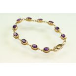 Amethyst 9ct yellow gold bracelet, eleven oval mixed cut amethyst, measuring approx 6.5mm x 4.5mm,