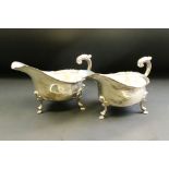 Pair of Edwardian silver sauce boats, plain polished body with pie crust rim raised on three hoof