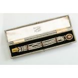 Garnet and pearl 9ct yellow gold bracelet, the oval clasp set with two rows of cream cultured