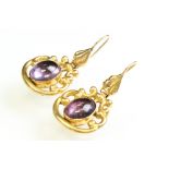 Pair of 19th century amethyst yellow metal drop earrings, the oval cabochon cut amethyst measuring