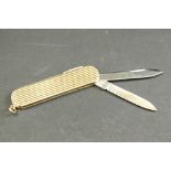 9ct gold cased folding penknife and scissor set, reeded body