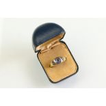 Sapphire unmarked yellow gold three stone ring, the principal oval mixed cut sapphire measuring