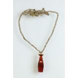 Carnelian yellow metal seal pendant, the carved carnelian with plain polished base, length approx