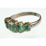 19th century green stone rose metal five stone ring, five graduated step mixed cut emeralds, the
