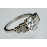 Art Deco diamond platinum ring, the central round brilliant cut diamond weighing approx 1.75 carats,