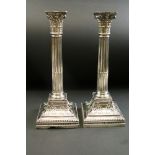 Pair of late Victorian silver Corinthian column candlesticks, the capital with cast scroll and