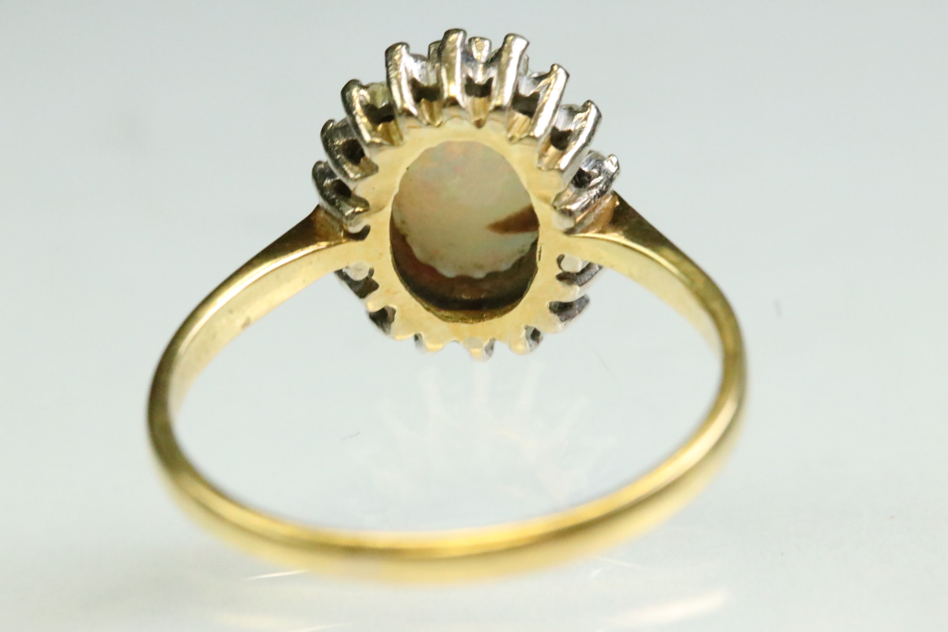 Opal and diamond 18ct yellow and white gold set cluster ring, the precious white opal displaying - Image 6 of 7