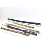 A collection of four vintage fishing rods to include a Hardy example.