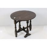 Oak Circular Tilt Top Table in the 17th century style raised on a turned and block folding base,