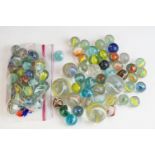 A small collection of vintage glass marbles contained within two bags.