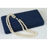 A two row sautoir cultured pearl necklace with diamond set clasp.
