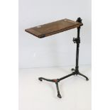 Victorian Reading Table, the folding oak rectangular top held on a painted cast iron adjustable
