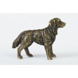 A miniature bronze figure of a golden retriever dog.