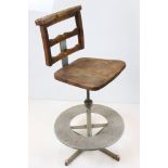 Early 20th century Architect's Swivel Chair, the elm and beech seat held on an adjustable metal base