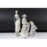 Four Nao Porcelain Figures including Girl holding a Dog, Girl holding a sheath of wheat, 31cm high