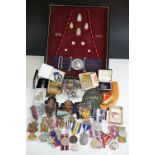 A group of military collectables to include a framed set of Royal Army Ordnance corps badges, a