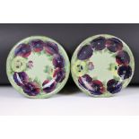 Pair of William Moorcroft Shallow Bowl or Plates decorated in the pansy pattern on green ground,
