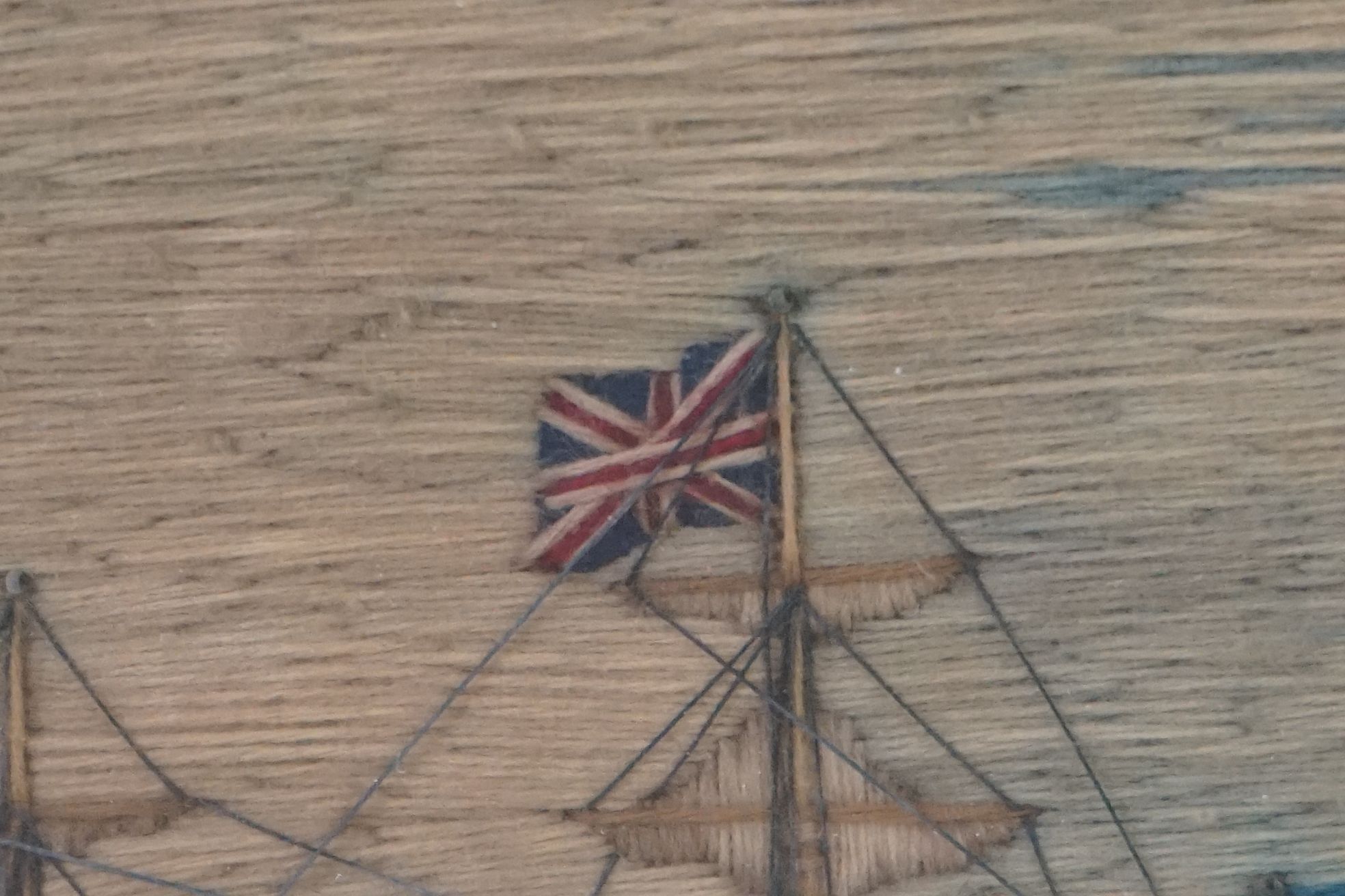 19th century Woolwork Embroidery of a Sailor stood on a rocky outcrop holding a flag with French and - Image 9 of 12