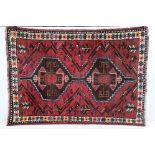 Eastern Red Ground Rug with geometric pattern within a shallow border, approximately 145cm x 109cm