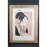Kitagawa Utamaro, a signed Japanese woodblock portrait of a lady in traditional costume, holding a
