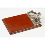 A fully hallmarked sterling silver notebook holder / desk clip mounted to polished wooden mount.