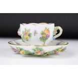 Meissen floral encrusted cup and saucer, decorated with insects and flowers