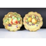 Pair of Coalport Cabinet Plates, hand painted with fallen fruits within a gilt wavy rim, one
