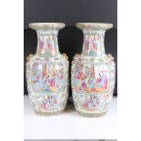 Pair of Chinese Cantonese Baluster Vases decorated in the Famille Rose palette with panels of