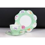 Aynsley 1930's ' Flower Handle ' Trio, each piece hand painted with panels of flowers on a green