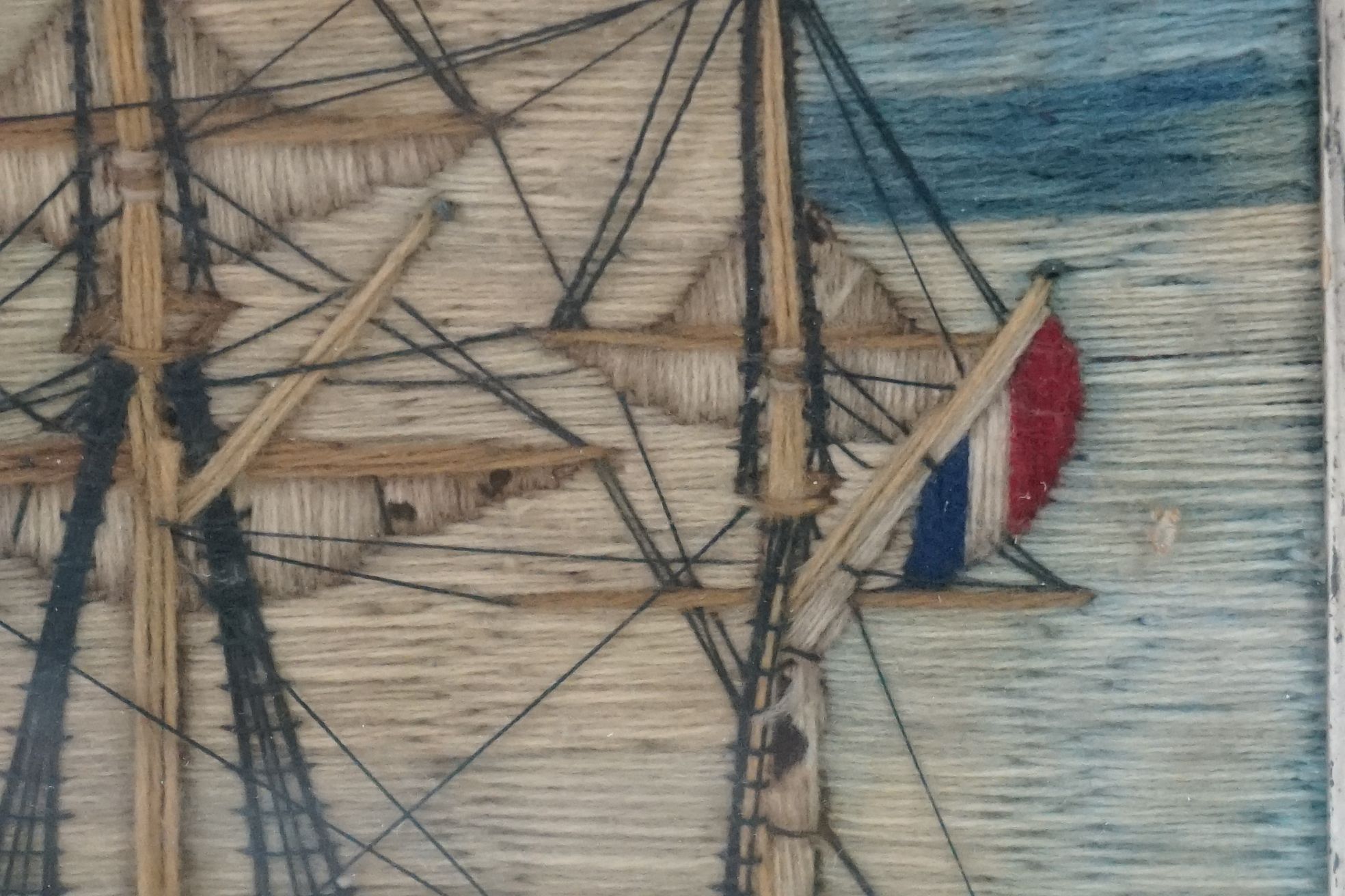 19th century Woolwork Embroidery of a Sailor stood on a rocky outcrop holding a flag with French and - Image 11 of 12