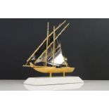 Gold Plated Model of a Yacht bearing the United Arab Emirates Flag, raised on a marble base, 22cm
