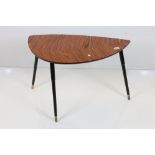 Mid century Retro Coffee Table with wood effect shaped top, raised on three black tapering legs,