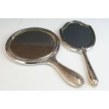 Two fully hallmarked sterling silver hand mirrors, both with engine turned decoration.