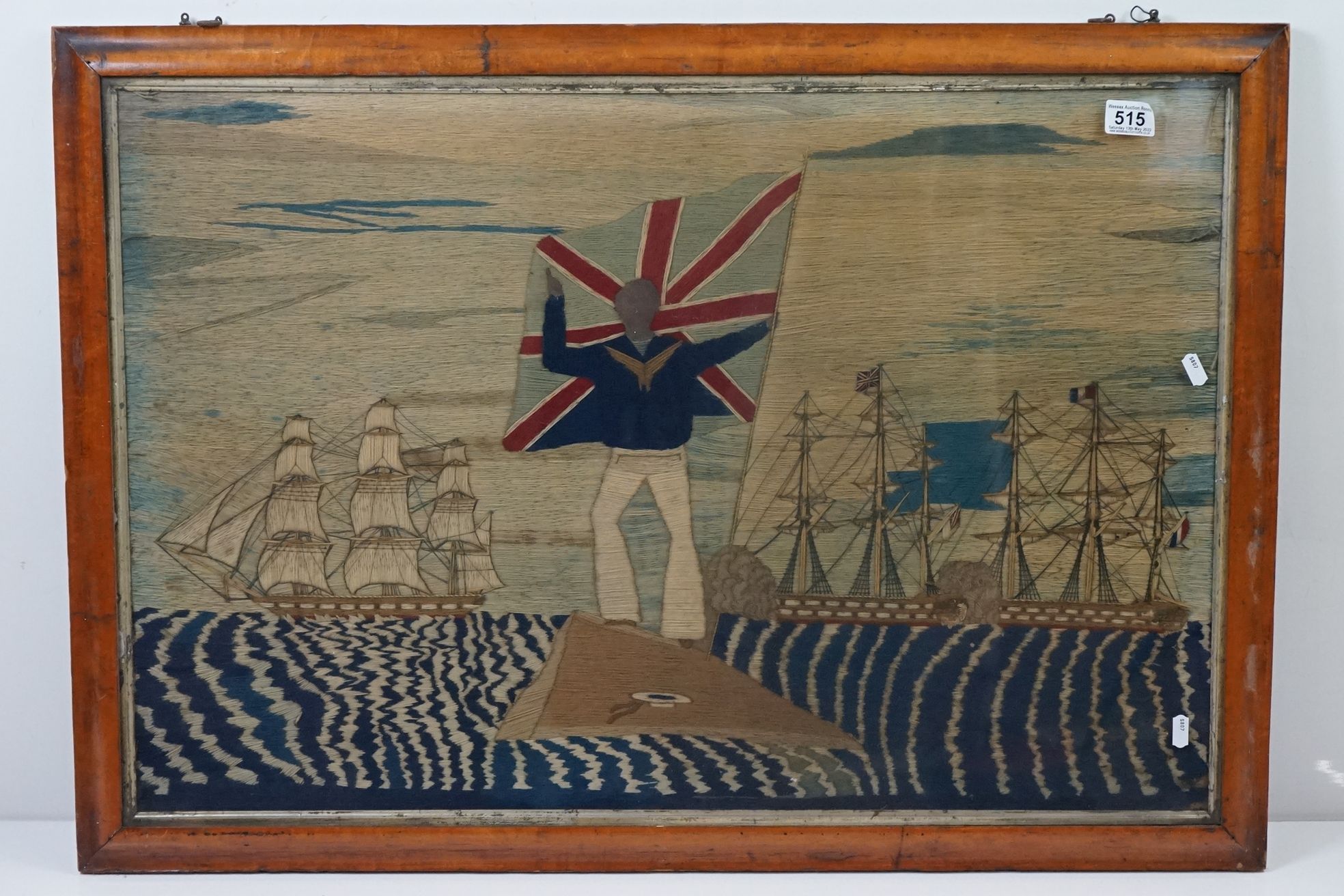 19th century Woolwork Embroidery of a Sailor stood on a rocky outcrop holding a flag with French and